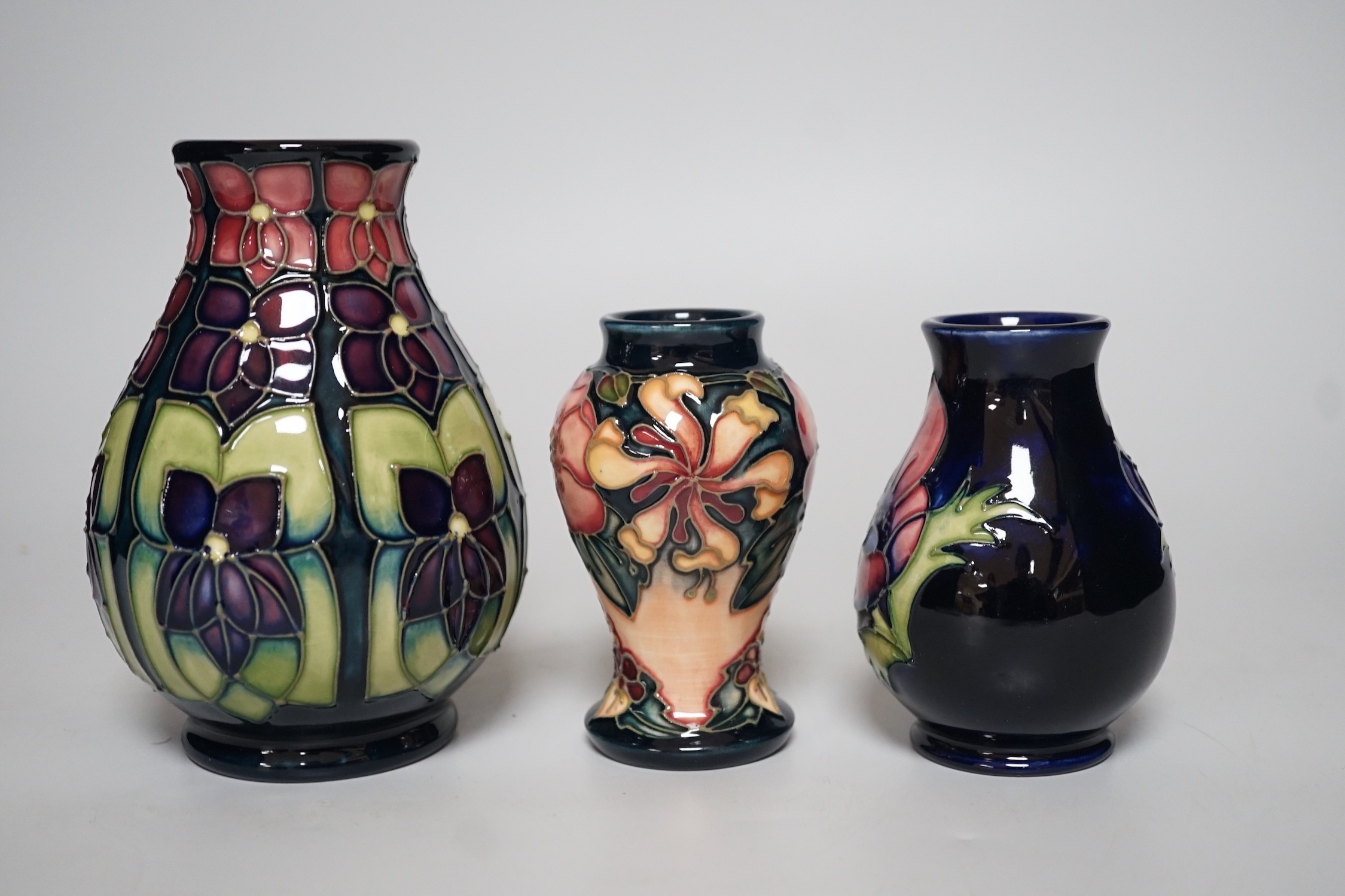 Three boxed Moorcroft vases of varying shapes, tallest 14cms high